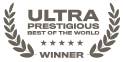 Ciemnoszara ikona odznaki w kształcie wieńca laurowego z koroną. W środku widnieje tekst: "ULTRA PRESTIGIOUS BEST OF THE WORLD" i pięć gwiazdek, a pod spodem słowo "WINNER".